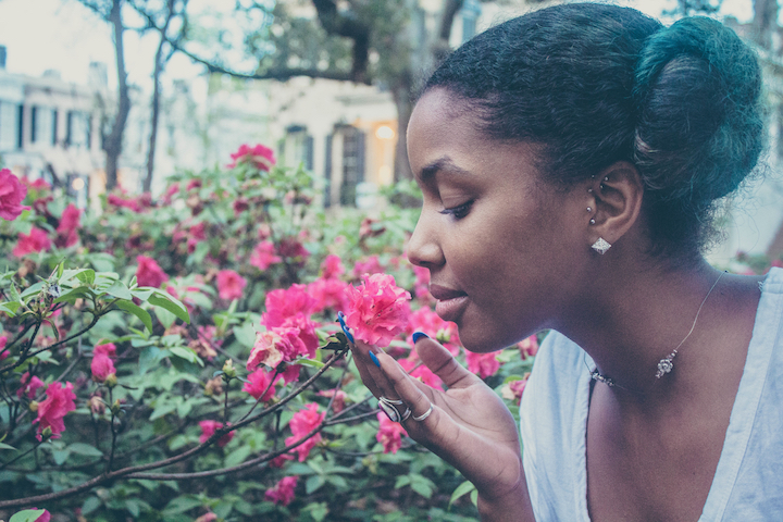 Image of a girl smelling a flower